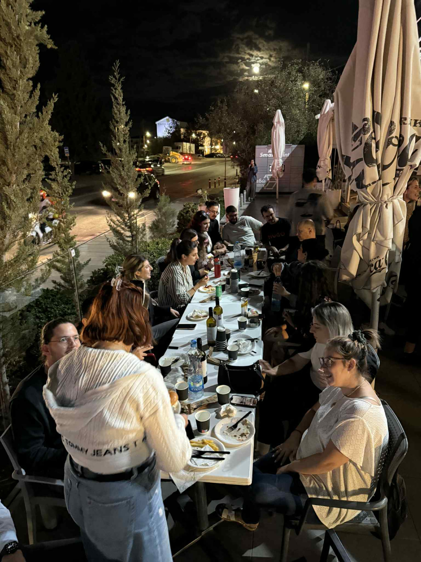 Infocredit Group team members gathered around a long table at the ICG Burger Night at Presse Café
