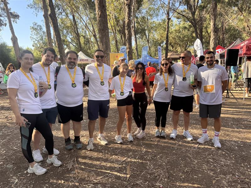 Infocredit Group corporate running team wearing medals at the EUROLIFE Run the Park marathon in Athalassa Park