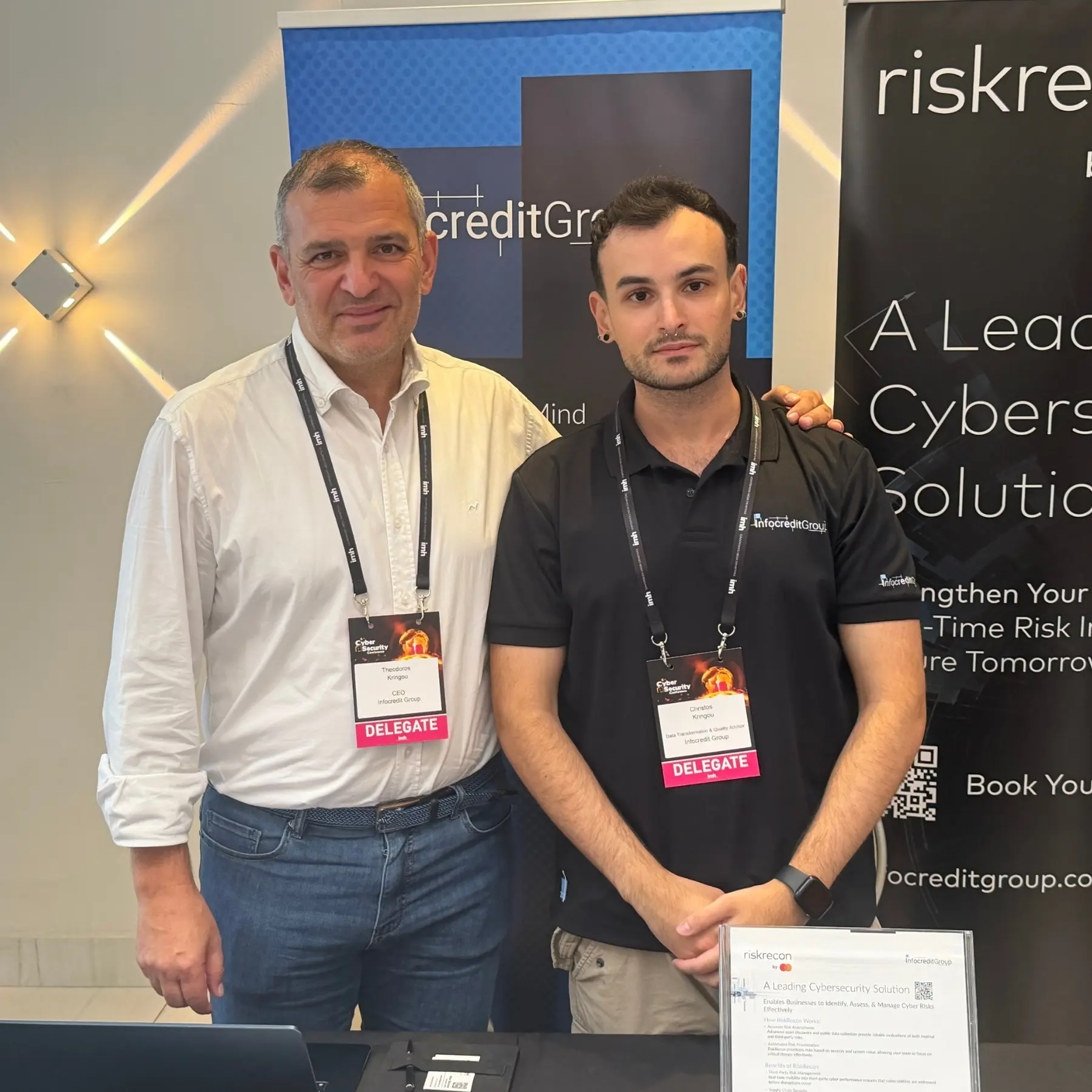 Infocredit Group representatives at the RiskRecon exhibition stand during the conference.
