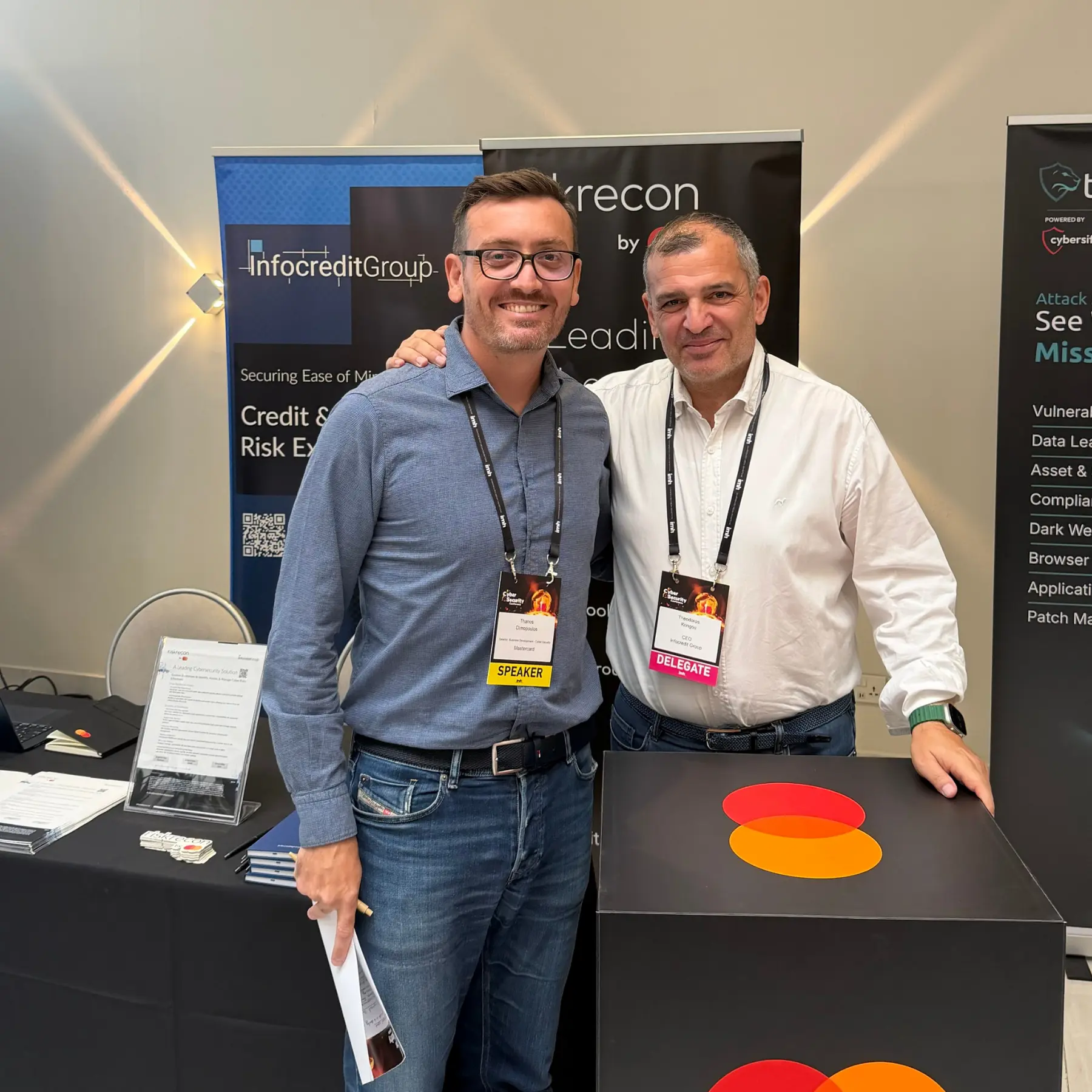 Mastercard cybersecurity speaker with Infocredit Group CEO Theodoros Kringou at the conference stand.